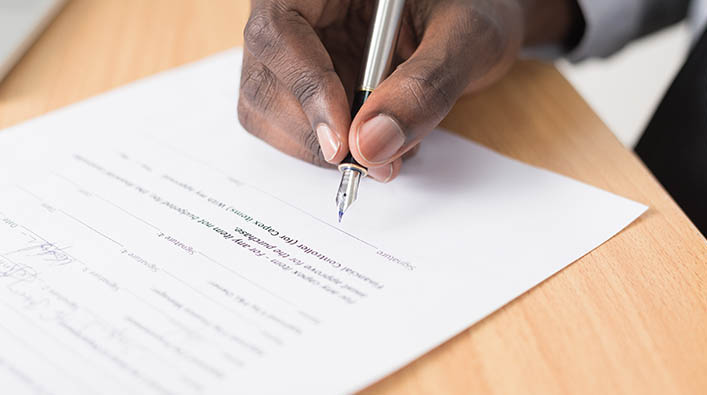 Documents being signed with a pen